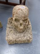 AN EARLY CARVED STONE ARCHITECTURAL ELEMENT (MOMENTO MORI) OF A SKULL.