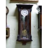 A VICTORIAN VIENNA WALL CLOCK IN MAHOGANY EBONISED CASE, WHITE ENAMEL TWO PIECE DIAL WITH SUBSIDIARY