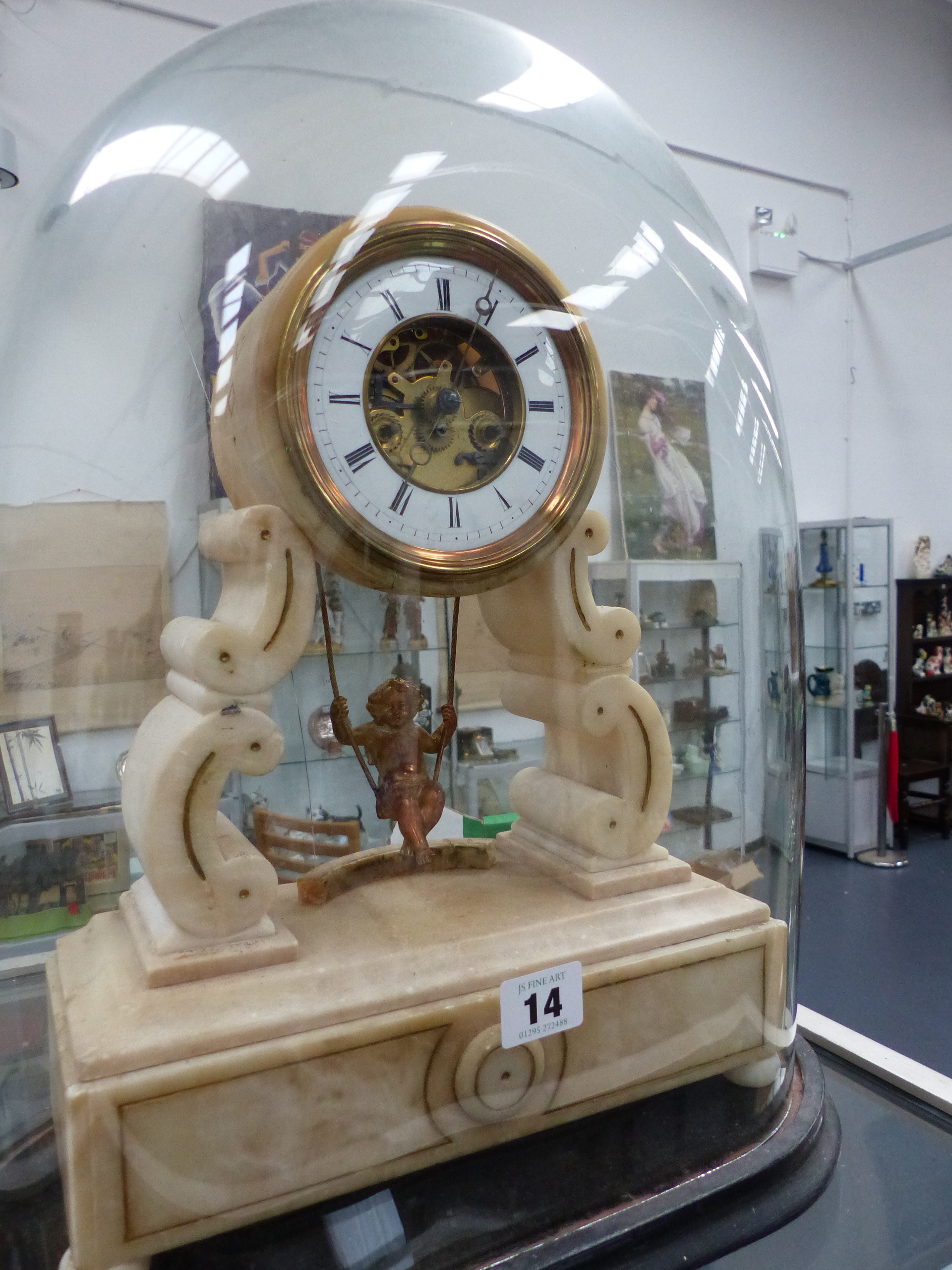 A VICTORIAN WHITE METAL MANTLE CLOCK WITH CHERUB SWING PENDULUM, WHITE ENAMEL CHAPTER RING WITH