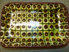 TWO ART POTTERY SHALLOW RECTANGULAR DISHES WITH SLIP WARE DECORATION. INDISTINCT POTTERS MARKS TO