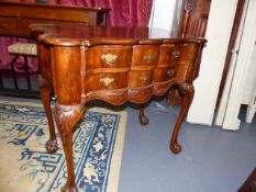 A GEO.I.STYLE WALNUT TWO DRAWER SIDE TABLE ON CARVED CABRIOLE LEGS. W.89cms.