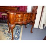 A GEO.I.STYLE WALNUT TWO DRAWER SIDE TABLE ON CARVED CABRIOLE LEGS. W.89cms.