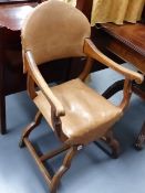 A PAIR OF UNUSUAL ARTS AND CRAFTS STYLE OAK X-FRAME ARMCHAIRS.