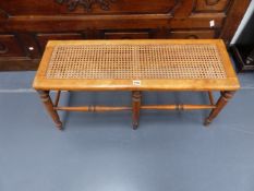 A VICTORIAN SATINBIRCH CANE TOP WINDOW SEAT. 92cms LONG.