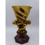 AN EARLY 20th.C.SWIRL FORM GILT BRONZE VASE SUPPORTED BY THREE SEA SPRITES ON OCTAGONAL MARBLE BASE.