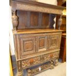 AN 18th.C.AND LATER OAK AND INLAID DUODARN CABINET WITH CARVED PANEL DECORATION. W.130cms