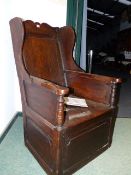 AN 18th.C.AND LATER PANELLED OAK WINGBACK LAMBING ARMCHAIR WITH BOX SEAT.