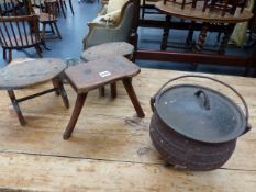 THREE RUSTIC SMALL STOOLS, A CAST IRON LIDDED CAULDRON,ETC.