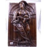 AN EARLY CARVED OAK PANEL OF A CLASSICALLY DRAPED LADY HOLDING A CHILD IN AN ARCHITECTURAL NICHE.