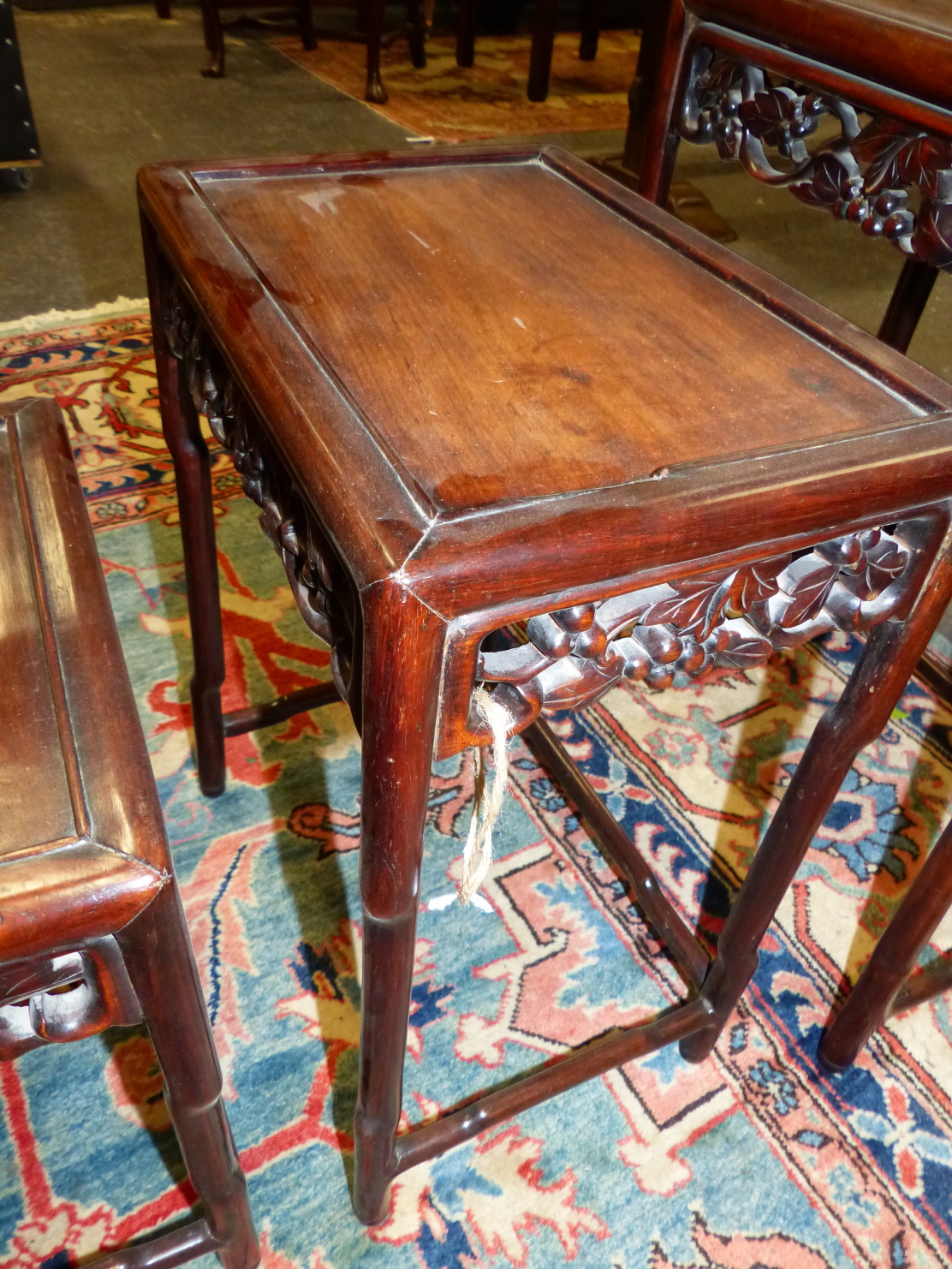 A NEST OF FOUR CHINESE CARVED HARDWOOD TABLES WITH PIERCED FOLIATE APRONS. - Image 8 of 19