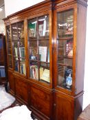 AN 18th.C.GEORGIAN FRUITWOOD BREAKFRONT BOOKCASE WITH FOUR GLAZED PANEL DOORS OVER CONFORMING