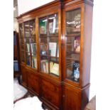 AN 18th.C.GEORGIAN FRUITWOOD BREAKFRONT BOOKCASE WITH FOUR GLAZED PANEL DOORS OVER CONFORMING