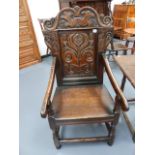 AN 18th.C.OAK WAINSCOT CHAIR WITH CARVED PANEL BACK.
