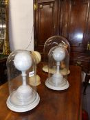 A GROUP OF MODERNIST SCULPTURES UNDER GLASS DOMES.