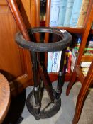 A LATE VICTORIAN EBONISED STICKSTAND TOGETHER WITH AN IVORY TOPPED WALKING STICK AND A THUMBSTICK.