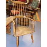 AN 18th.C.AND LATER COMB BACK ARMCHAIR WITH ELM SEAT AND SHAPED OAK CREST RAIL.