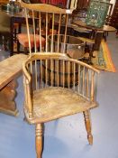 AN 18th.C.AND LATER COMB BACK ARMCHAIR WITH ELM SEAT AND SHAPED OAK CREST RAIL.