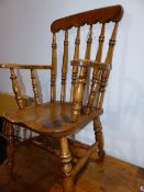 AN ANTIQUE COUNTRY KITCHEN SPINDLE BACK ARMCHAIR.