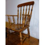 AN ANTIQUE COUNTRY KITCHEN SPINDLE BACK ARMCHAIR.