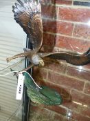 A FINELY CAST COLD PAINTED BRONZE FIGURE OF AN EAGLE CLUTCHING A SALMON, SIGNED INDISTINCTLY. H.