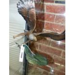 A FINELY CAST COLD PAINTED BRONZE FIGURE OF AN EAGLE CLUTCHING A SALMON, SIGNED INDISTINCTLY. H.