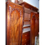 A CARVED MAHOGANY VICTORIAN AND LATER TRIPLE COMPACTUM WARDROBE WITH CENTRAL SLIDES AND DRAWERS