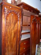 A CARVED MAHOGANY VICTORIAN AND LATER TRIPLE COMPACTUM WARDROBE WITH CENTRAL SLIDES AND DRAWERS