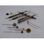 FIVE PROPELLING WRITING INSTRUMENTS TOGETHER WITH A QUANTITY OF VARIOUS STICK PINS.