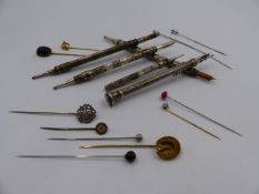 FIVE PROPELLING WRITING INSTRUMENTS TOGETHER WITH A QUANTITY OF VARIOUS STICK PINS.