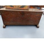 AN ANTIQUE OAK PLANK COFFER WITH NAIVE CARVED DECORATION OF MERMAIDS, DRAGONS, GRAPEVINE,ETC. W.