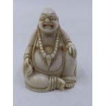 AN ANTIQUE CARVED IVORY FIGURE OF BUDDHA.