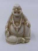 AN ANTIQUE CARVED IVORY FIGURE OF BUDDHA.