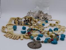 A SELECTION OF ETHNIC BEADS AND NECKLACES TO INCLUDE A WHITE METAL EASTERN CALLIGRAPHY DECORATIVE