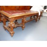 AN ANTIQUE CARVED OAK FRENCH STYLE GALLERY BENCH/ WINDOW SEAT, FLUTED STRETCHERED LEGS AND NAILED