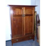 A LATE VICTORIAN/EDWARDIAN LIBERTY & Co ARTS AND CRAFTS WALNUT TWO DOOR WARDROBE WITH SPLAY CORNICE.