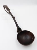 AN UNUSUAL ANTIQUE CARVED SERVING SPOON/LADLE WITH SCROLLED HANDLE DECORATED WITH A BIRD AND