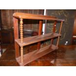 A VICTORIAN MAHOGANY THREE TIER WALL SHELF WITH BOBBIN SUPPORTS. W.197cms.