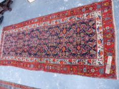 AN ANTIQUE PERSIAN MALAYER RUNNER. 308x124cms.