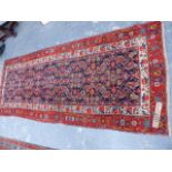 AN ANTIQUE PERSIAN MALAYER RUNNER. 308x124cms.