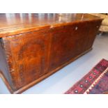 A LARGE IMPRESSIVE 18th.C. COFFER WITH CARVED PLANK FRONT DEPICTING ENGLISH ROYAL ARMS FLANKED BY