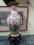 A CHINESE CANTONESE BALUSTER FORM VASE ON ASSOCIATED CARVED HARDWOOD BASE. VASE H.44cms.