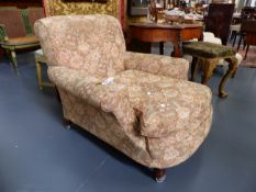 A LATE VICTORIAN HOWARD STYLE DEEP SEATED ARMCHAIR WITH LATER CASTORS.