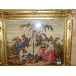 A VICTORIAN NEEDLEPOINT PANEL OF AN EASTERN FAMILY IN GILT FRAME. OVERALL 54 x 62cms.