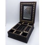 A CARVED INDO COLONIAL HARDWOOD LIFT TOP DRESSING CASE WITH OVERALL INTRICATE FOLIATE DECORATION,