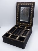 A CARVED INDO COLONIAL HARDWOOD LIFT TOP DRESSING CASE WITH OVERALL INTRICATE FOLIATE DECORATION,