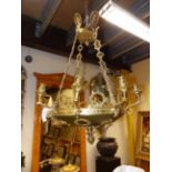 A GILT AND PATINATED BRONZE EMPIRE STYLE EIGHT LIGHT CHANDELIER DECORATED WITH WREATHS AND