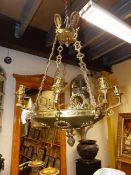 A GILT AND PATINATED BRONZE EMPIRE STYLE EIGHT LIGHT CHANDELIER DECORATED WITH WREATHS AND