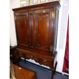 AN 18th.C.OAK TWO DOOR CABINET WITH SHELVED INTERIOR ON ASSOCIATED OAK THREE DRAWER STAND. H.195 x