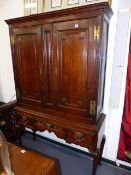 AN 18th.C.OAK TWO DOOR CABINET WITH SHELVED INTERIOR ON ASSOCIATED OAK THREE DRAWER STAND. H.195 x