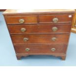 A LATE GEORGIAN OAK CHEST OF TWO SHORT AND THREE LONG DRAWERS ON BRACKET FEET. W.97 x H.99cms.